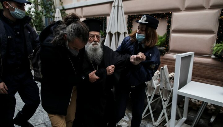 Police detain a cleric in Athens for shouting, "Pope, you're a heretic!"