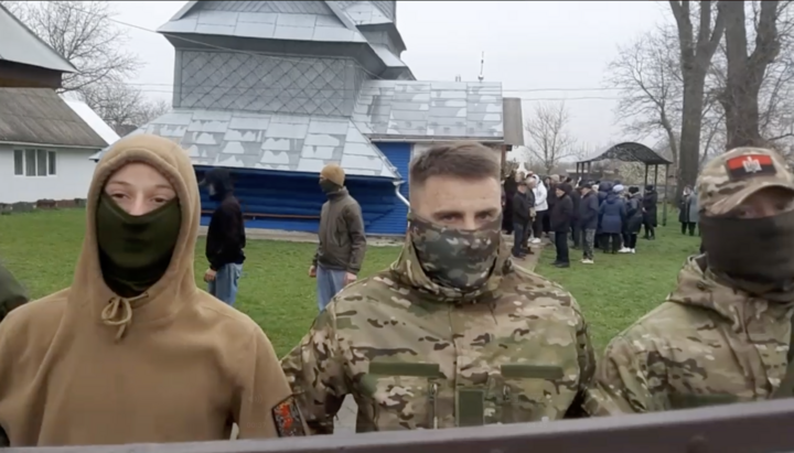 Militants in balaclavas block the community's access to their church. Photo: UOJ