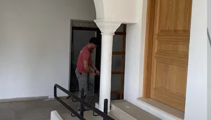 A locksmith changing the locks at the entrances to the diocesan administration of Paphos. Photo: Omega