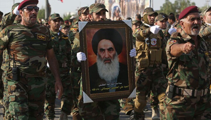 Shiite fighters of Iraq with a portrait of Iraqi Shiite leader Ali al-Sistani. Photo: Middle East Online